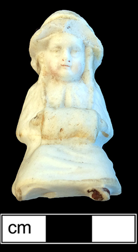 Small sitting doll, made of bisque porcelain, with the legs broken off. 4.75cm x 2.75cm x 3cm, from 18BC27.
